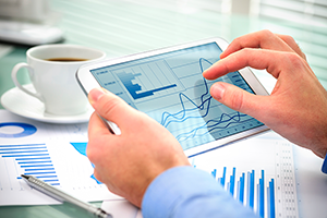 businessman_holding_ipad_with_charts_300px