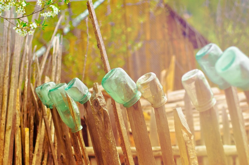 glass bottles on fence