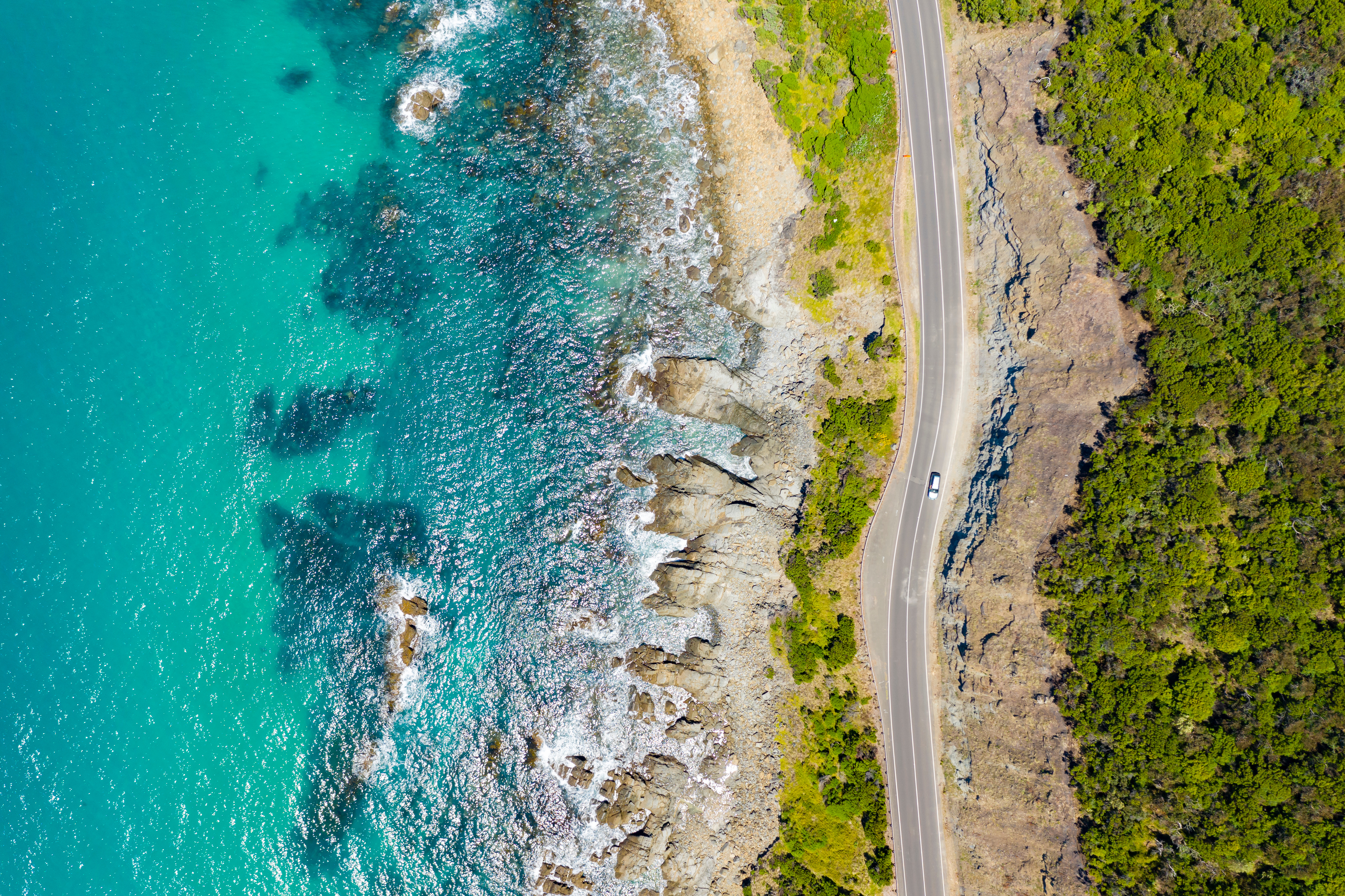 an image of a road next to the ocean in australia