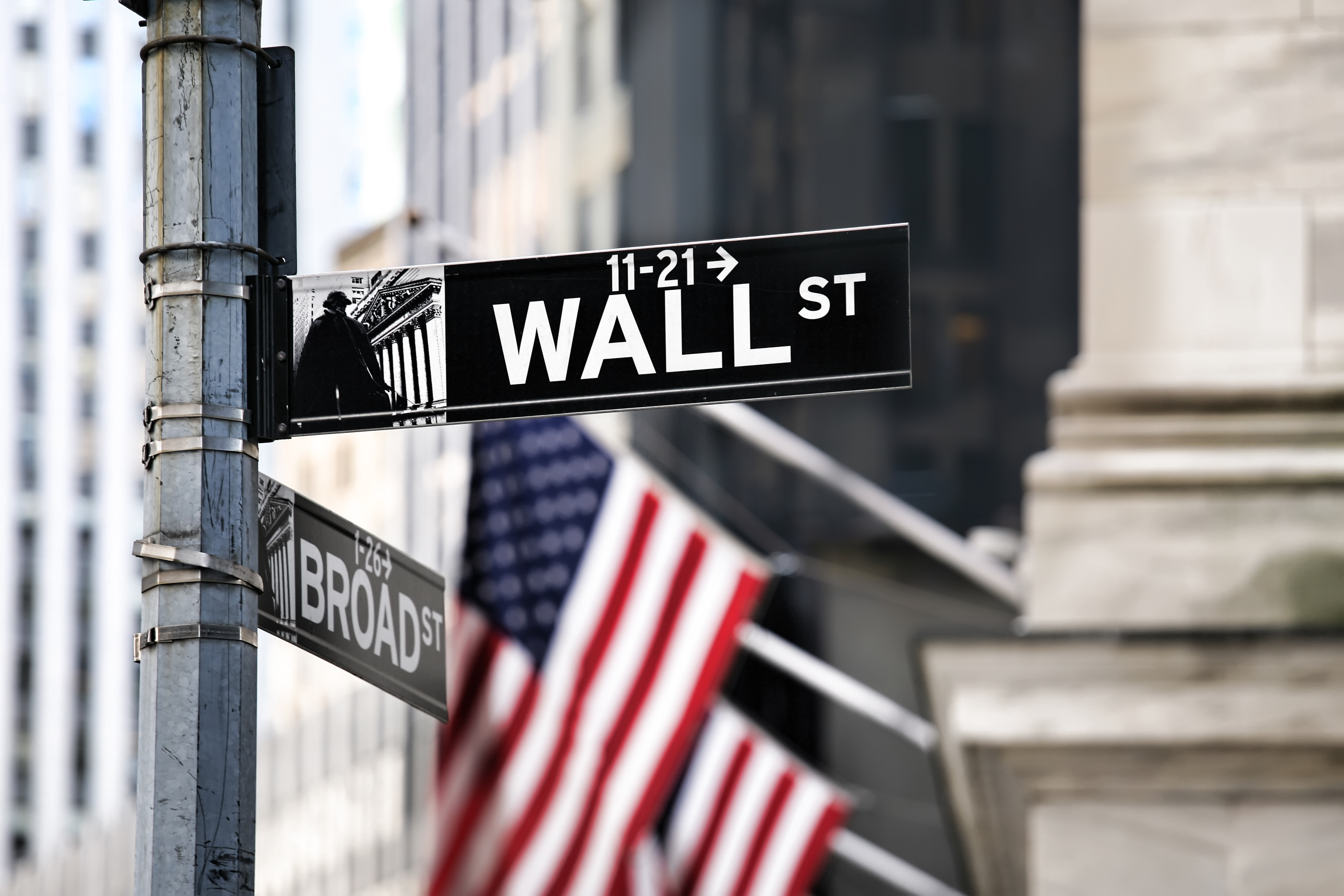 an image of wall street and the us flags